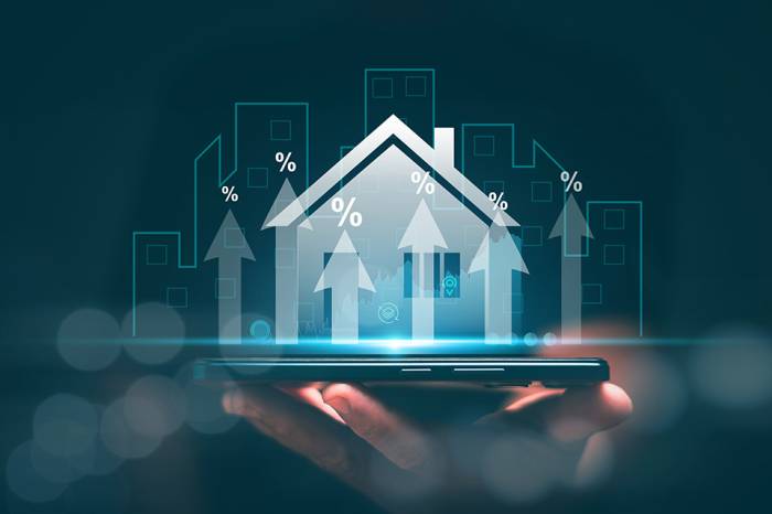 Foto: Hologramm eines Hauses auf einer Hand